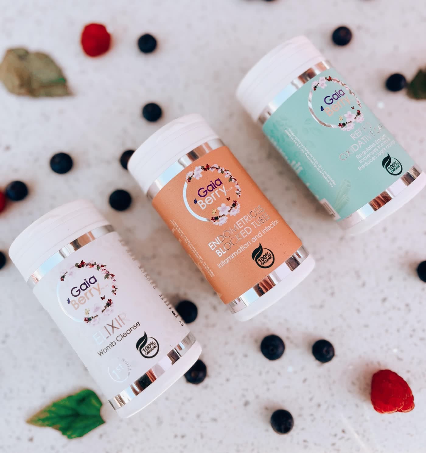 GaiaBerry natural fertility products with fresh berries on a cream surface